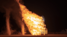 wooden structrure burning at burning man